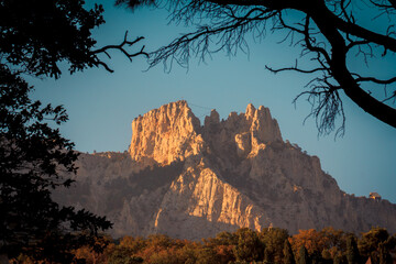 Top of Ai-Petri mountain in Crimea, view from Vorontsov park, natural photo frame. Rock lit by sun in evening at sunset. Wonderful wallpaper or background. Famous natural attraction. Panorama mount