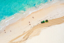 Aerial Drone View Of Tractor Cleaning The Beach From Seaweed. Bavaro Beach In Punta Cana, Dominican Republic
