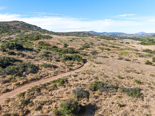 Poster - Aerial view of Los Penasquitos Canyon Preserve during dry season. Urban park with mountain and trails in San Diego, California. USA