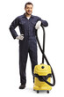Male cleaner in a uniform with a professional vacuum cleaner