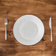© Patrick Herzberg - empty plate with knife and fork on wooden background