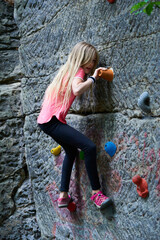 Wall Mural - Child Girl having fun during rock climbing training on boulder wall