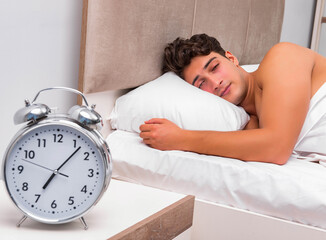 Man having trouble waking up in the morning