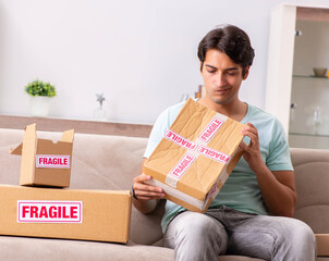 Man opening fragile parcel ordered from internet