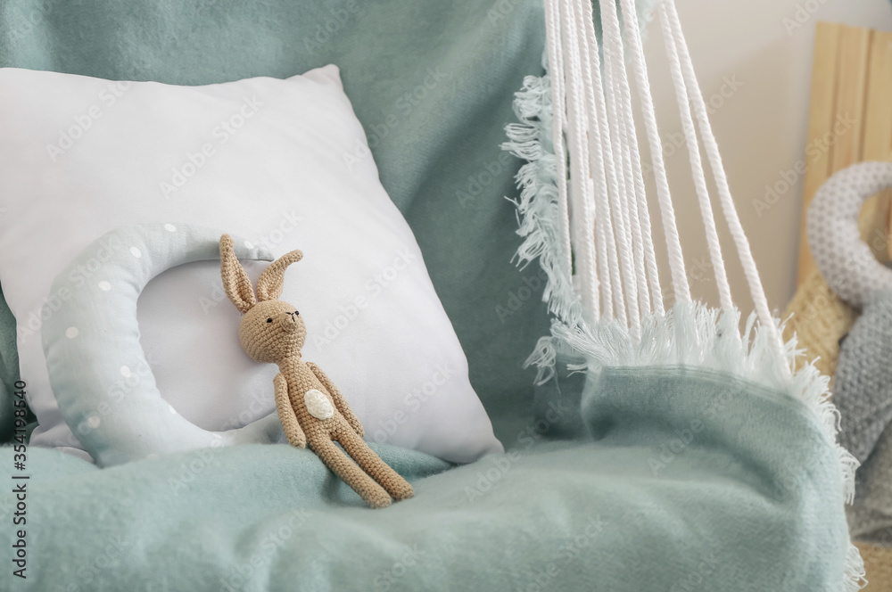 Hanging lounger with toy in children's room