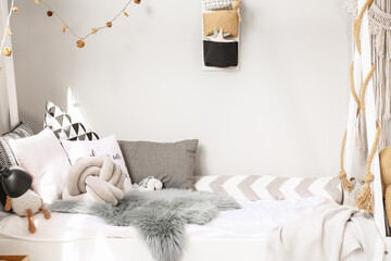 Comfortable bed in interior of children's room