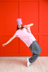 Poster - Young female hip-hop dancer against color wall