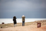 Fototapeta Kosmos - couple walking on beach
