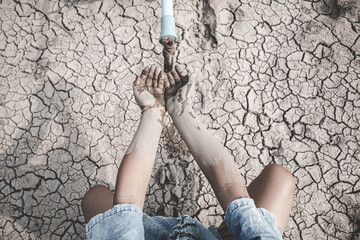 The little boy waiting for drinking water to live through this drought, Concept drought and crisis environment.