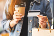 A woman holding shopping bags , credit card and coffee cup for online shopping concept