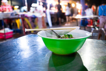 Wall Mural - Asian food. A plate of beef soup at a street food night market