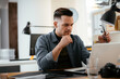 © JustLife - Young businessman using laptop in his office.  Handsome man working in office.
