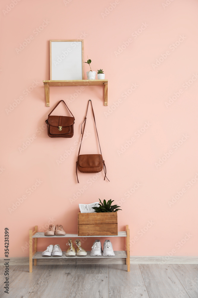 Stylish interior of modern hall with shoes on stand