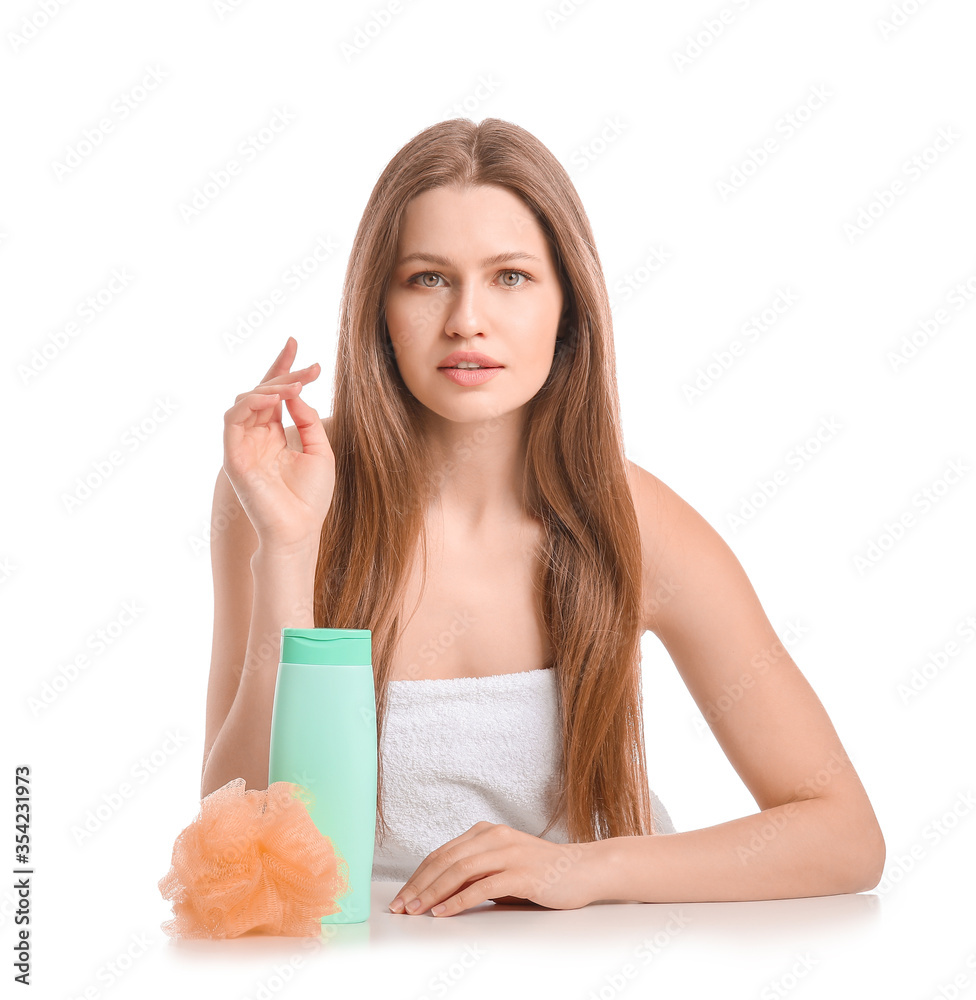Beautiful young woman with shower gel on white background
