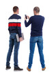© ghoststone - Back view of two man in sweater with mobile phone.