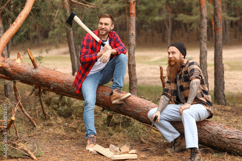 Portrait of handsome lumberjacks in forest