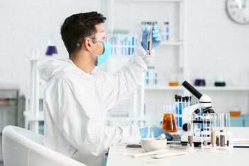 Scientist studying samples of soil in laboratory