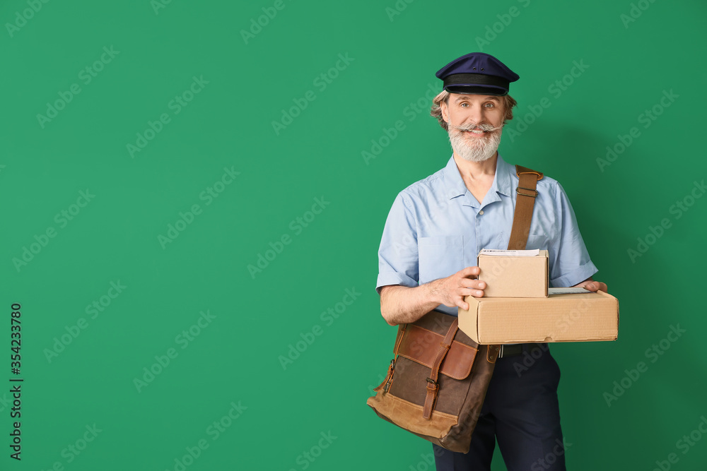 Handsome old postman on color background