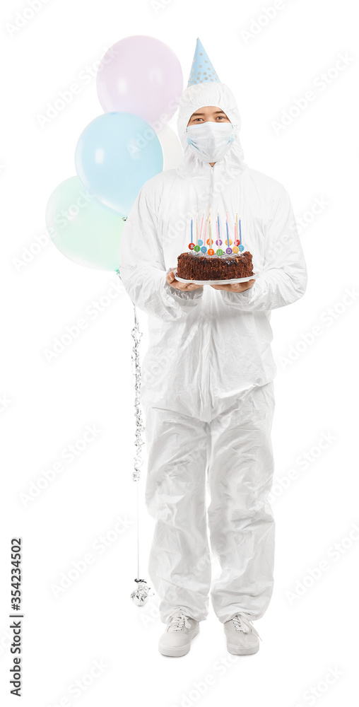 Asian man in biohazard suit and with Birthday cake on white background. Concept of epidemic