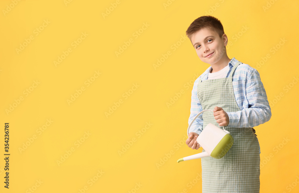 Cute little gardener on color background