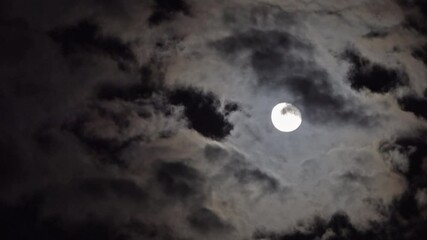 Wall Mural - full moon moving between clouds