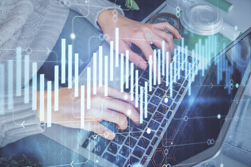 Double exposure of woman hands typing on computer and forex chart hologram drawing. Stock market invest concept.