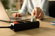 © PheelingsMedia - Woman hand plugging plug on socket at night using laptop