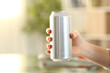© PheelingsMedia - Woman hand holding a soda drink can at home