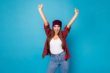 Poster - Photo of pretty stylish crazy overjoyed lady students party entertainment rejoicing raise fists arms winner competition wear casual hat plaid shirt jeans isolated blue color background