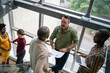 © JonoErasmus - Diverse businesspeople talking together on stairs in an office staircase