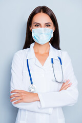 Canvas Print - Portrait of pretty female doctor crossed hands wear medical safety sterile mask on face, pandemic corona virus prevention protection concept 2020 covid19