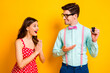 © deagreez - Dear its for you.Two people amazed girl geek nerd man give her car present on valentine day impressed wear red dotted dress suspenders shirt isolated over bright shine color background