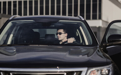 businessman driving new car