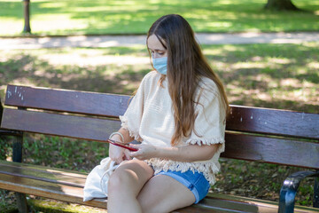 girl sitting on the street with face mask