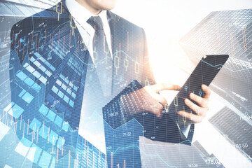 Poster - Businessman holding tablet and digital falling chart hologram