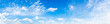 Panorama of a blue sky with white clouds as a backround