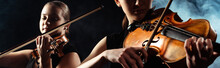 Attractive Musicians Playing On Violins On Dark Stage With Smoke, Website Header