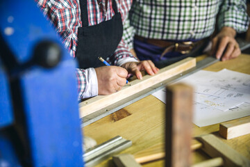 Wall Mural - Unrecognizable senior couple working in a carpentry workshop