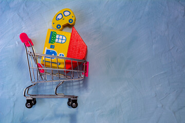 A shopping cart containing a house and a car. Concept of sales and purchases of real estate and cars.