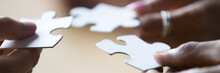 Close Up Photo Hands Of Multi Ethnic People Hold Diverse Pieces Of Puzzle, Team Assembling Jigsaw Joining Fragments, Teamwork, Search Find Solution Concept. Horizontal Banner For Website Header Design