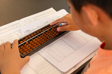 Boy Practicing Abacus (Japanese Traditional Calculation Tool Which Strengthen Mind Calculation)