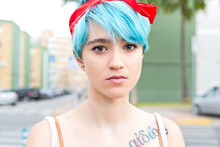 Portrait Of Serious Young Woman With Blue Dyed Hair
