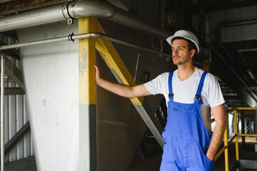 Wall Mural - Portrait of factory worker. Young handsome factory worker.