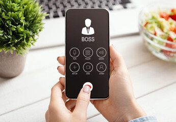 Female Hand Holding Phone With Boss Incoming Call
