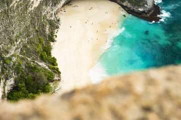 Wall Mural - (Selective focus) View from above, stunning aerial view of a T-Rex shaped cliffs with the beautiful Kelingking Beach bathed by a turquoise sea. Nusa Penida, Indonesia..