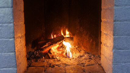 Burning logs in a cozy fireplace. Fire background.