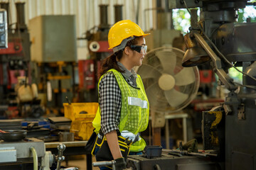 Poster - Female Mechanic working and checking machine in factory.