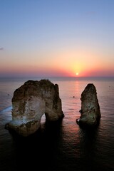 Wall Mural - beautiful vertical shot of pigeons' rock beirut lebanon and the sunset over the sea