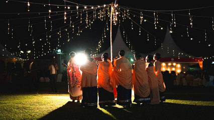 Wall Mural - African wedding in Uganda, beautiful ladies in national clothes, bridesmaids with bride in the evening, nightlight decoration, magical wedding concept