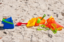 Top, Front View, Close Distance Of, A Child's Plastic, Colorful, Beach, Toys, On A Tropical, Sandy, Beach On Gulf Of Mexico, On A Sunny Morning